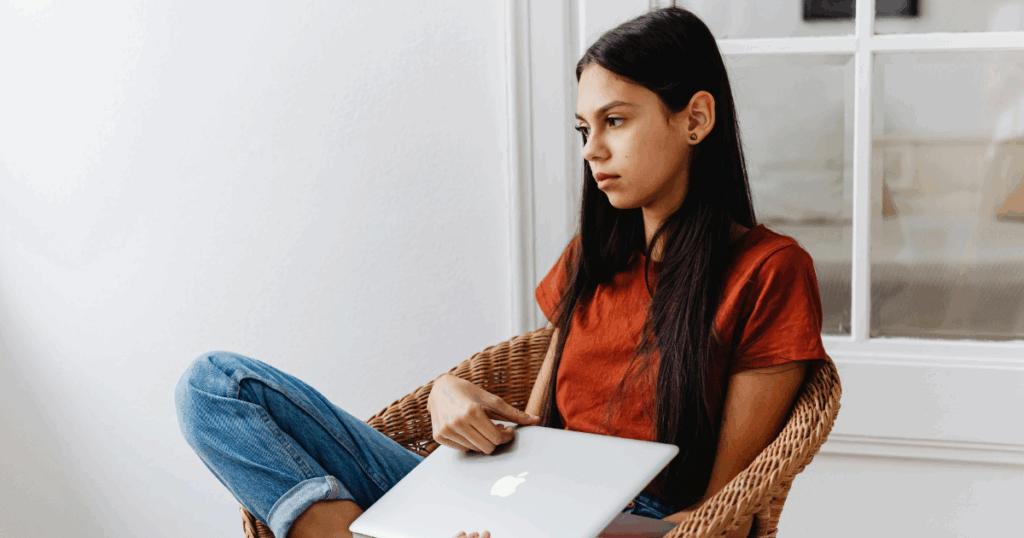 Woman with laptop addressing Ketamine Withdrawal challenges, resources for addiction recovery and mental health support.